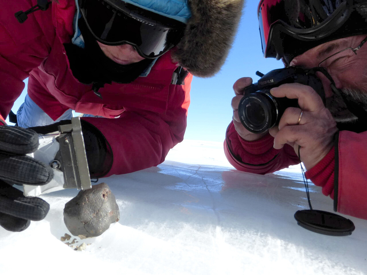 © NASA/JSC/ANSMET Alex Meshik and Morgan Nunn Martinez collecting a meteorite in Antarctica's Miller Range during the 2013-2014 ANSMET field season. ANSMET is the Antarctic Search for Meteorites program. morg_and_alex